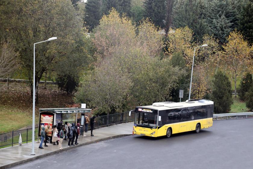 Durakta otobüsbekleyen yolcular ve durağa yanaşan İETT otobüsü