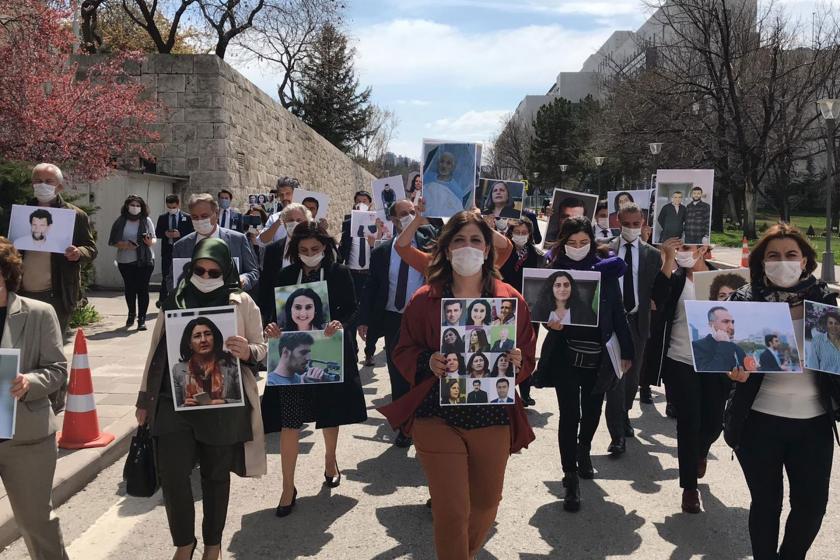 HDP milletvekilleri, tutuklu siyasetçilerin fotoğraflarıyla Meclis bahçesinde yürüyor.