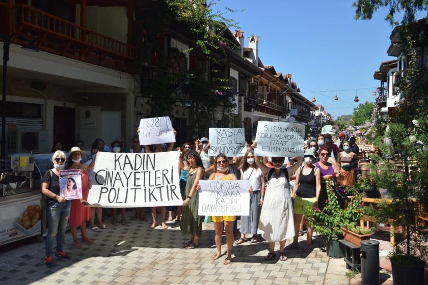 Kadın cinayetleri politiktir pankartı arkasında yürüyen, elinde döviz tutan kadınlar