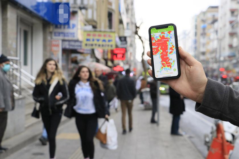 Diyarbakır'da sokakta yürüyenler ve HES uygulaması açık telefon