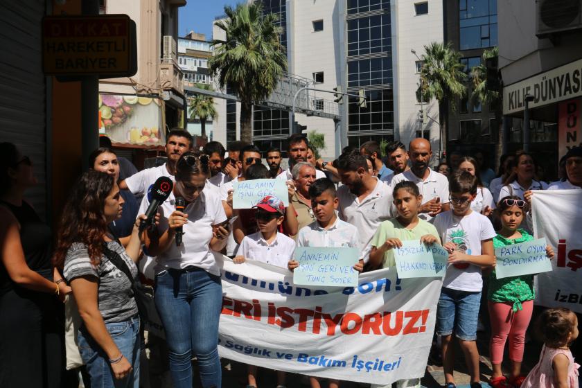 Fotoğrafta basın açıklaması yapan işçiler ve onlalra destek veren çocuklar yer alıyor