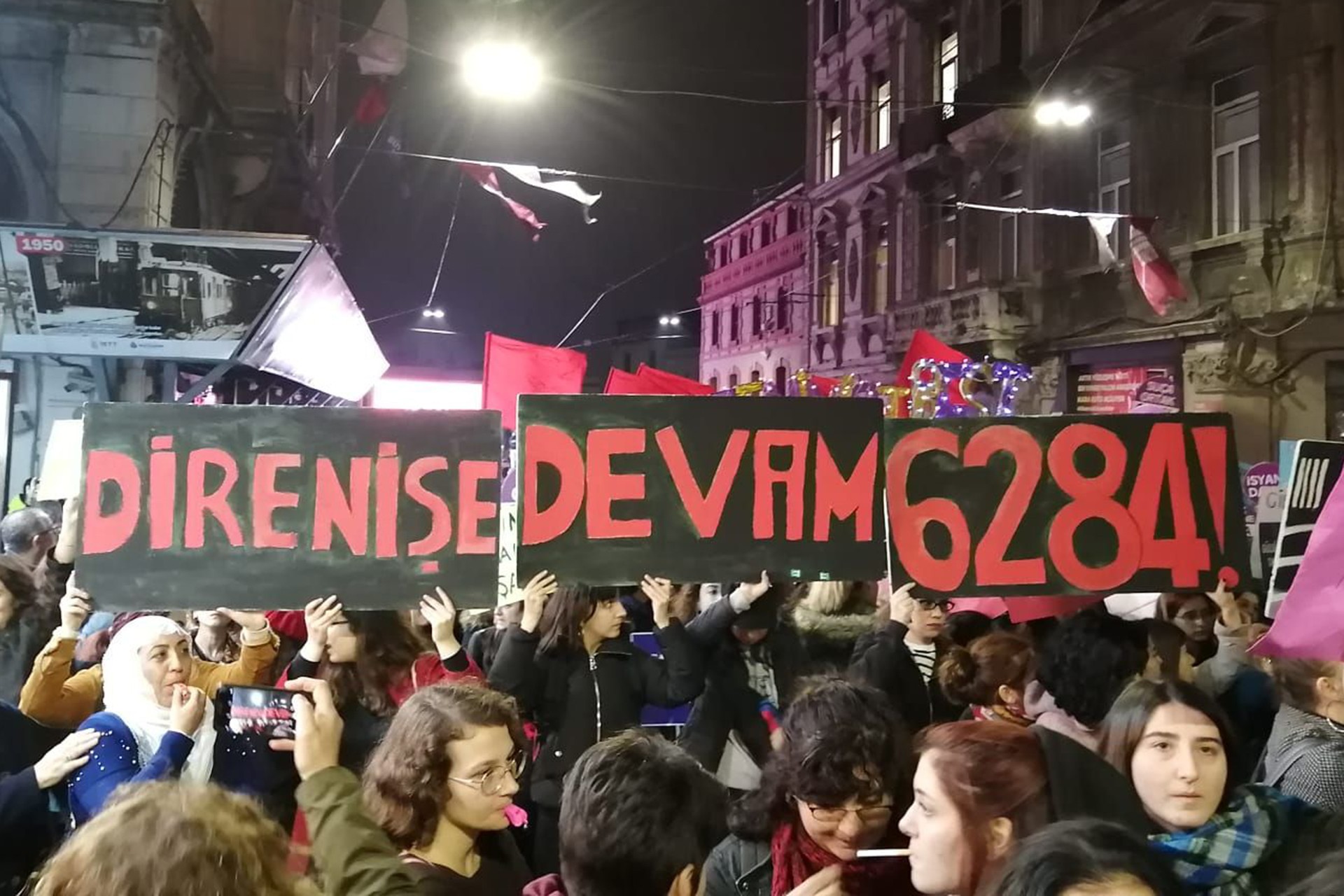 Kadınlar, İstiklal Caddesi'nde 'Direniş devam, 6284!' pankartları ile yürürken.