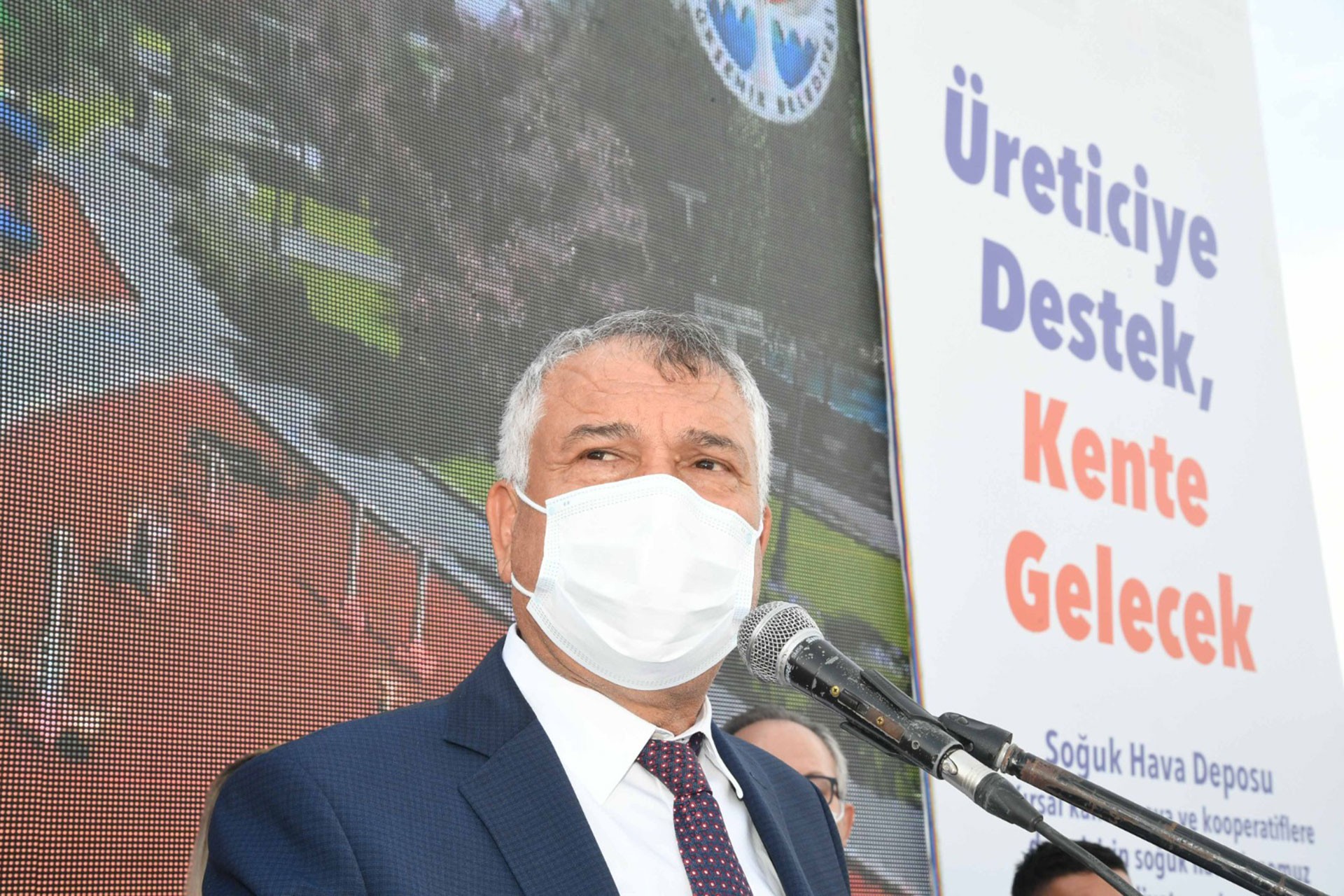 Zeydan Karalar yüzünde maske, kürsüde konuşuyor