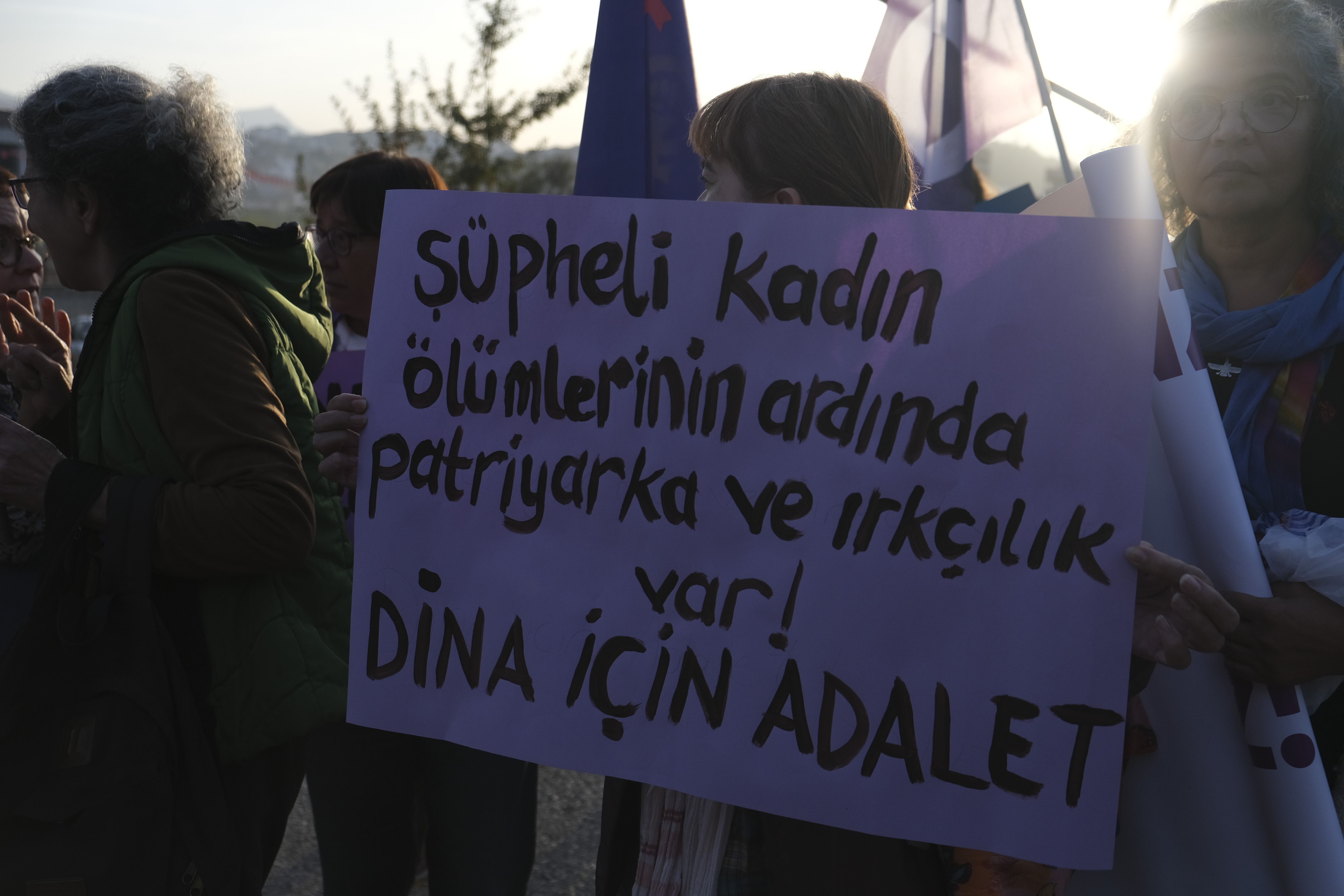 Ellerinde Dina için sloganların yazılı olduğu pankartları tutan kadınlar